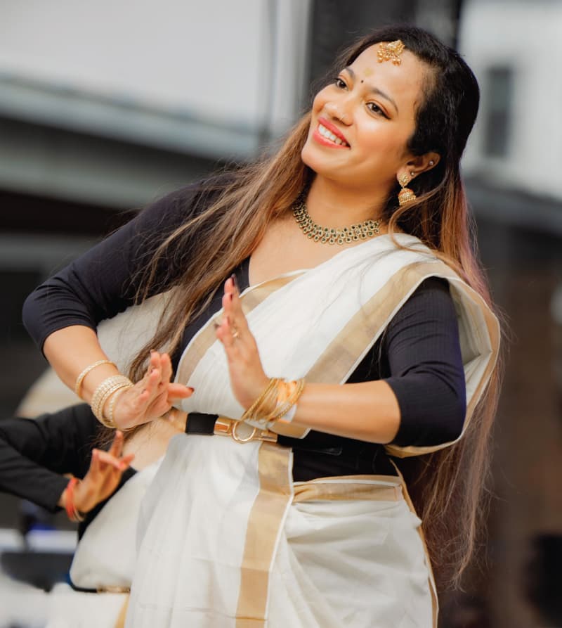 Pooja, Incident Response Manager, performing with her Indian classical dance group in a traditional outfit.