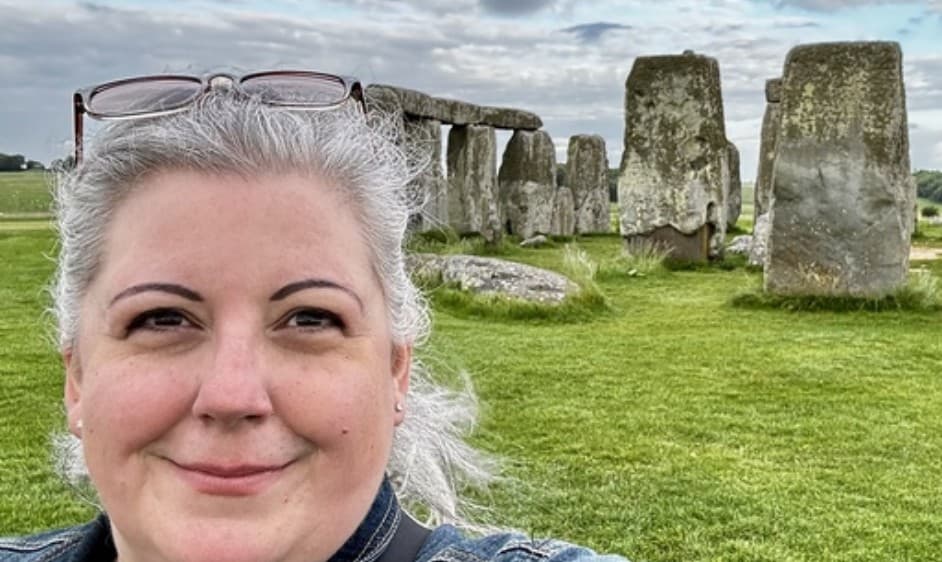 A selfie of VP of Growth and Solutions, Marlowe, standing in front of a historic UK stone circle.